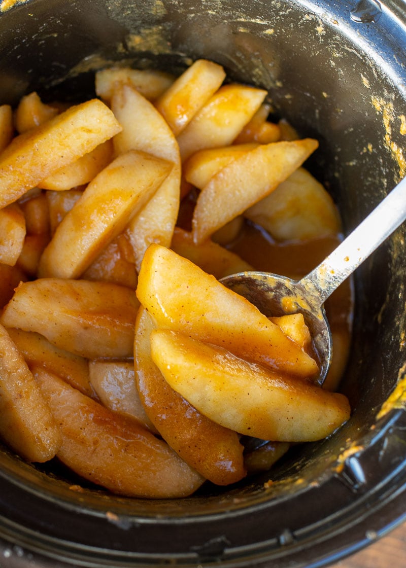 These Slow Cooker Pumpkin Spiced Apples are the ultimate autumn comfort food! Serve these warm spiced apples with vanilla ice cream and toasted pecans for the perfect Fall dessert!