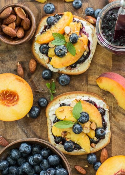 This simple Sweet Peach Bruschetta combines the best flavors of Summer! Fresh peaches, blueberries and mint make for an impressive combination!