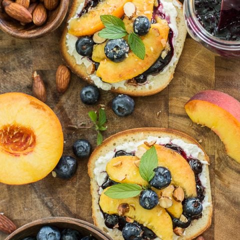 This simple Sweet Peach Bruschetta combines the best flavors of Summer! Fresh peaches, blueberries and mint make for an impressive combination!