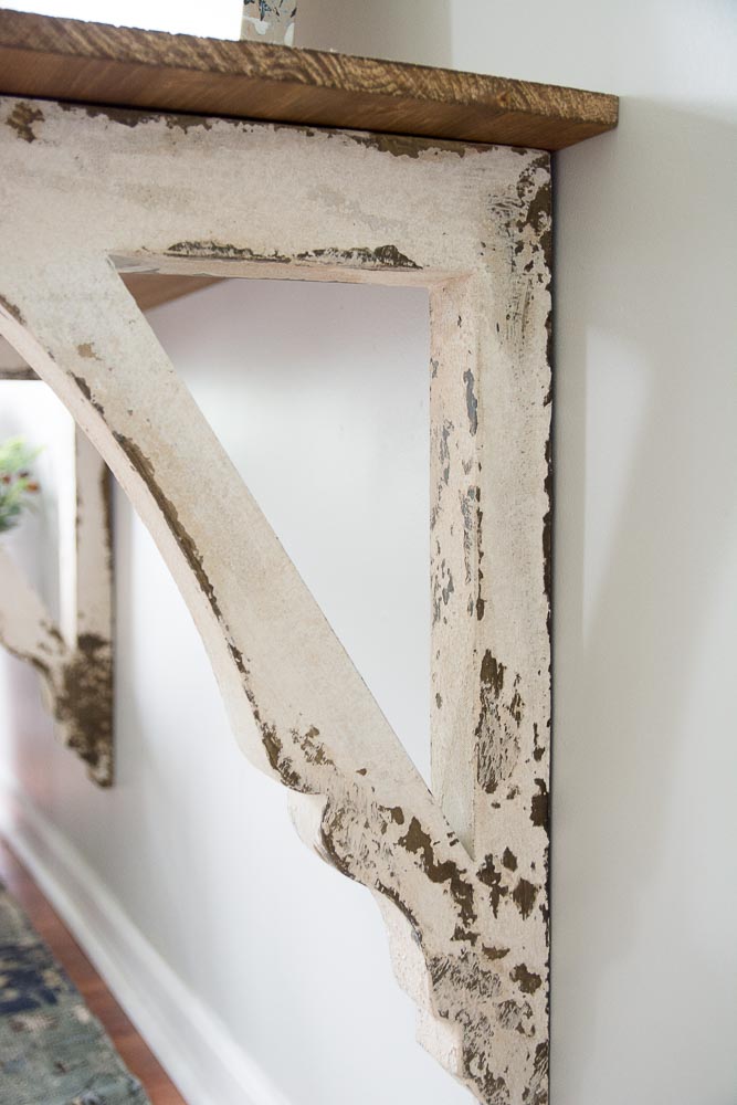 This super easy DIY Corbel Table adds a ton of farmhouse charm to any space! See how you can easily create this look in three simple steps!