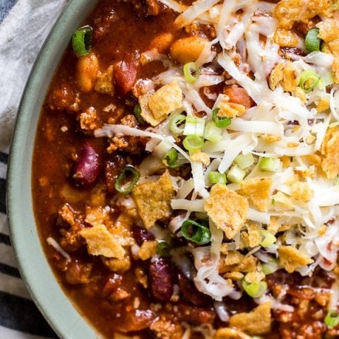 This is the Best Turkey Chili recipe! Browned turkey, two kinds of beans, tomatoes and spices make this an easy dinner you will love! Slow cooker option also!