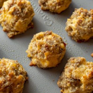 Overhead view of sausage, egg, and cheese bites on a baking sheet