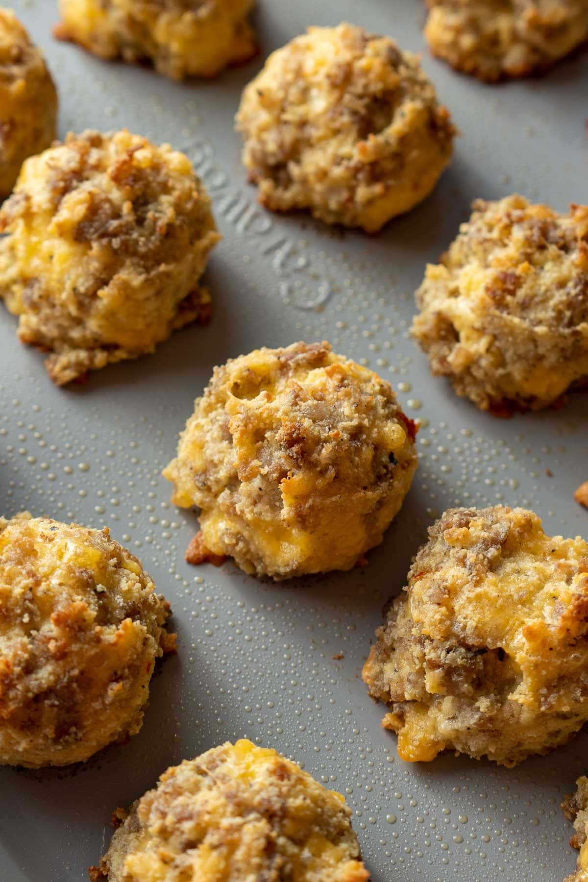 Overhead view of sausage, egg, and cheese bites on a baking sheet