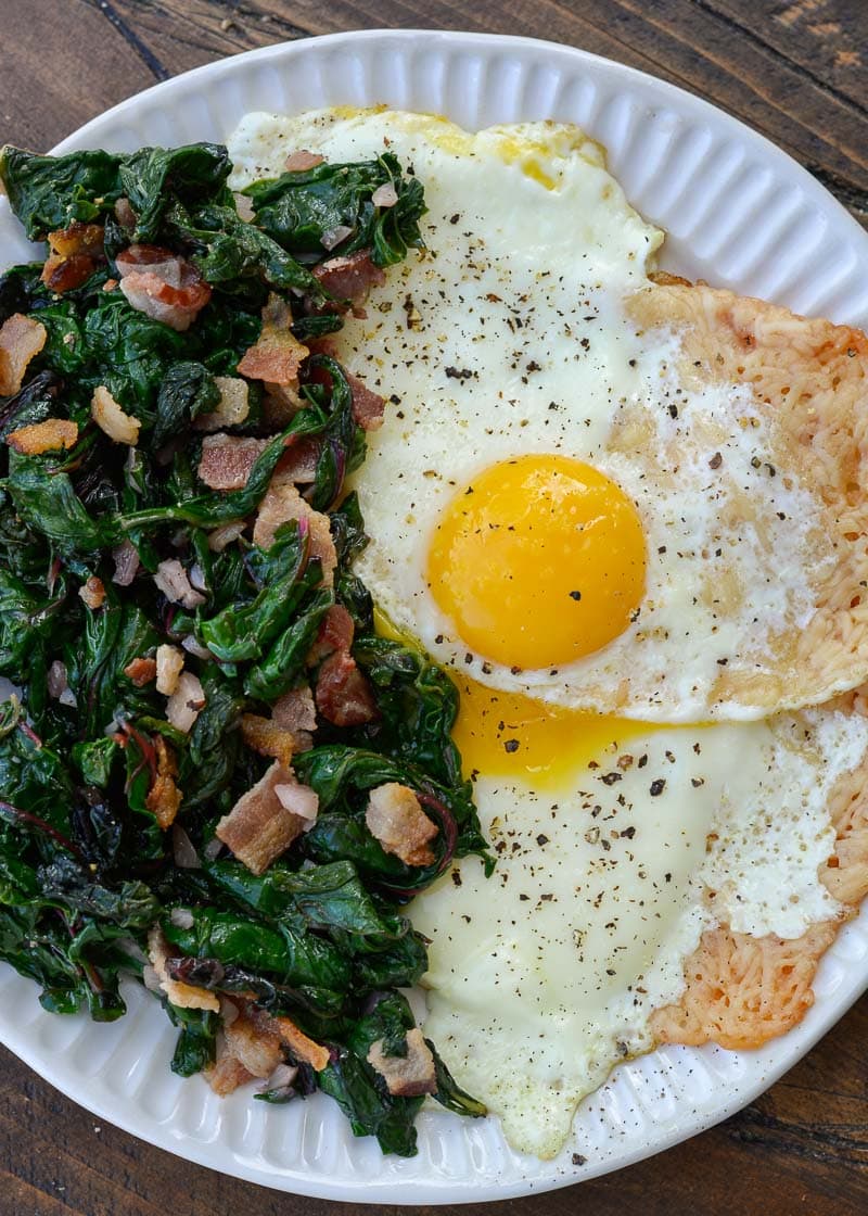 Parmesan Eggs are served with salty bacon and sautéed Swiss Chard for the perfect low carb breakfast recipe!