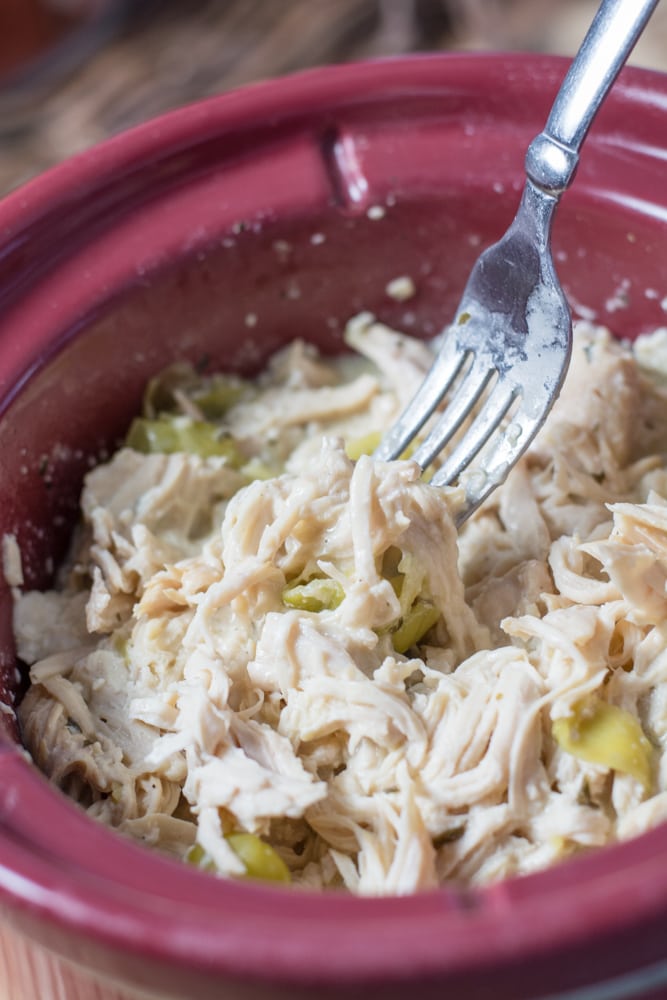 Closeup of crockpot ranch chicken in a slow cooker insert. 