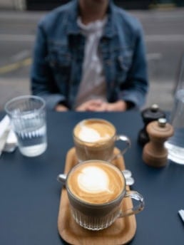 a shot of two flat whites at a cafe in paris