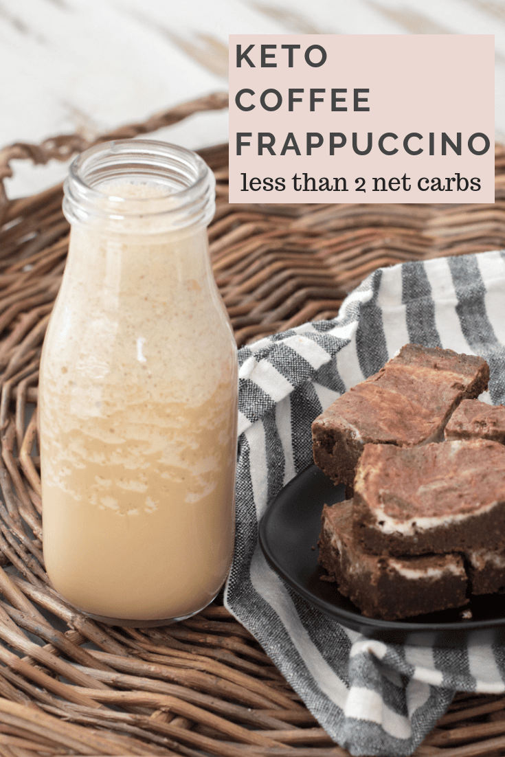 A copycat starbucks coffee frappuccino in a glass milk bottle next to a plate of brownies