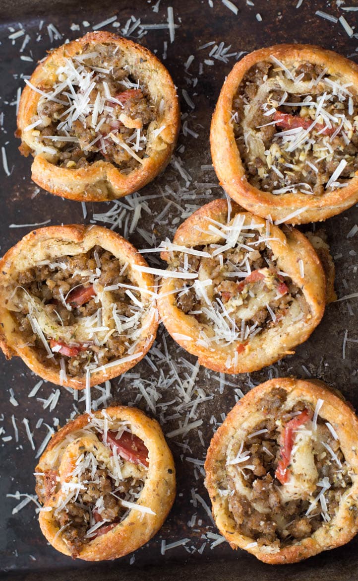 overhead view of six gluten free pizza rolls sprinkled with cheese 