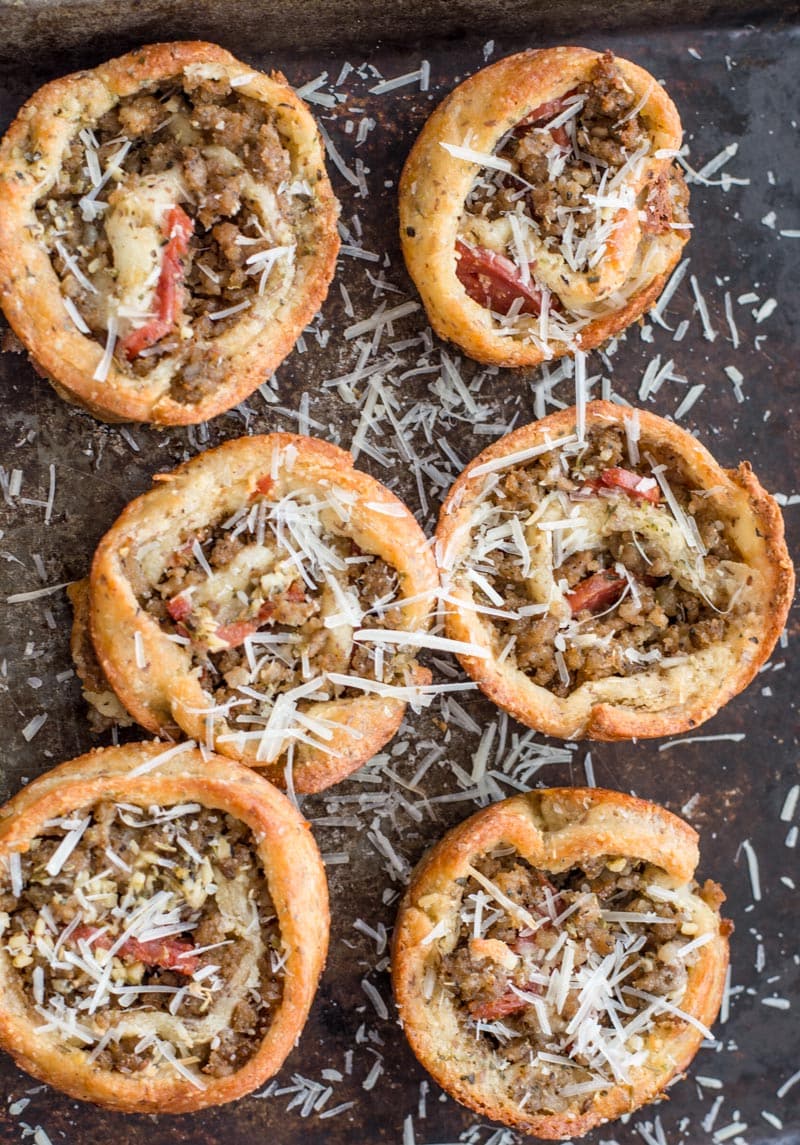 overhead view of six keto pizza rolls sprinkled with cheese 