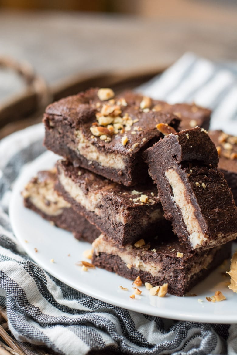 keto peanut butter brownies piled on a white plate 