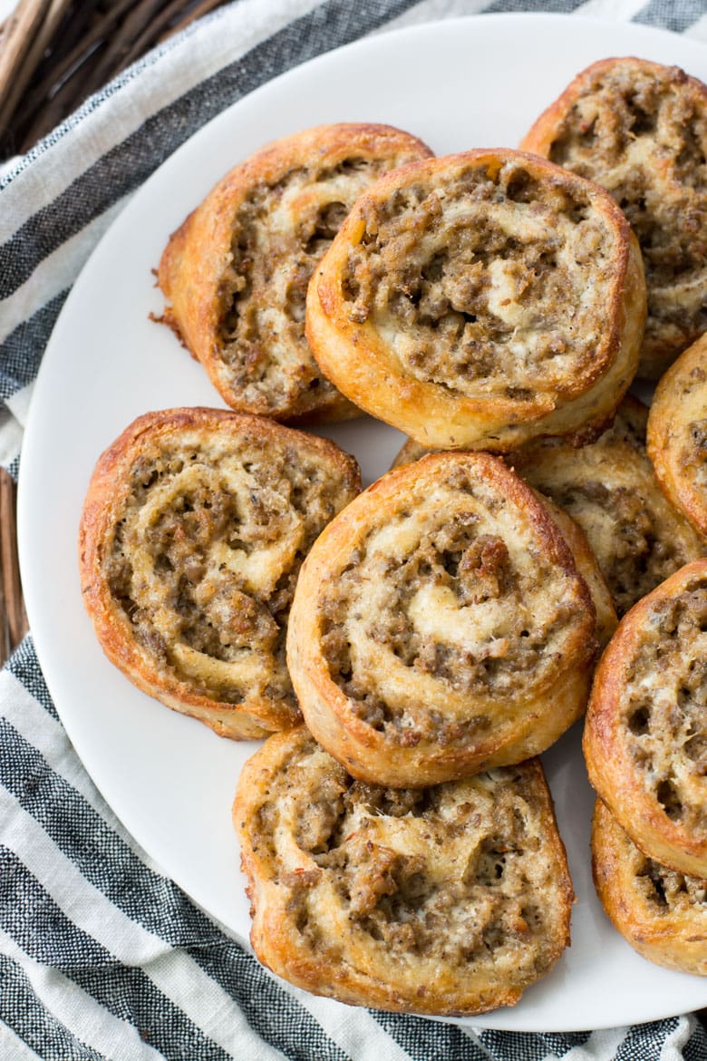 overhead view of keto sausage pinwheels on a white plate 