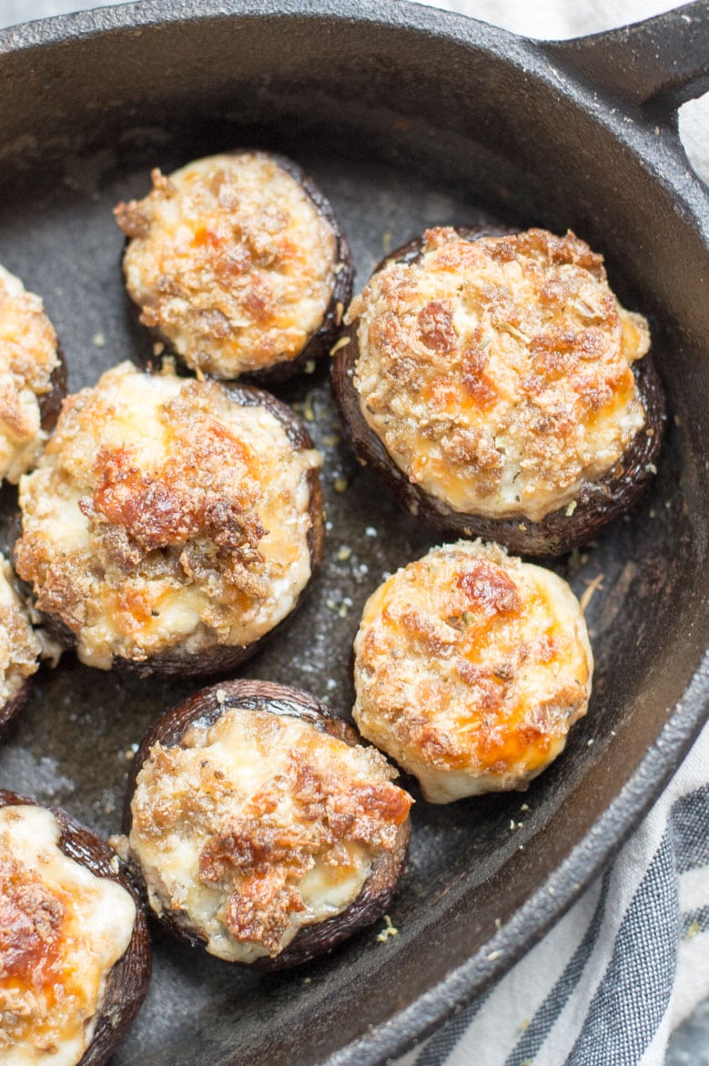 overhead view of sausage stuffed mushrooms in a cast iron skillet 