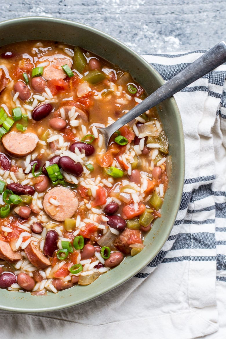 Overhead view of a bowl of red beans and rice with sausage. 