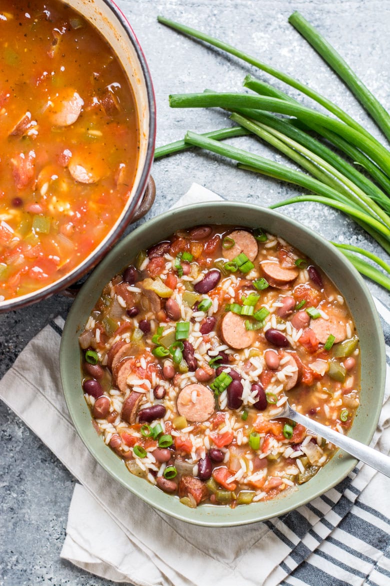 Overhead view of a bowl of red beans and rice with sausage. 