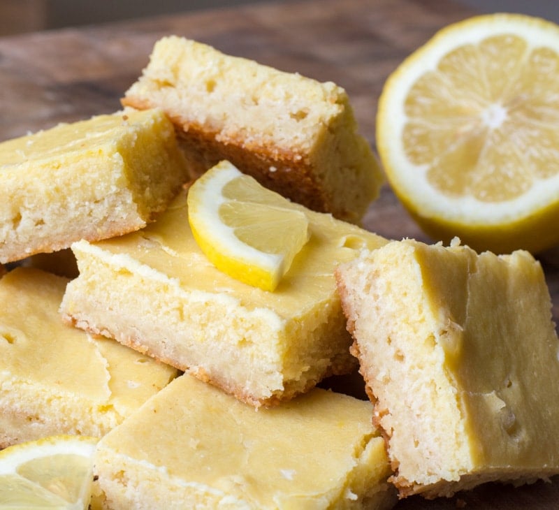 Gluten free lemons bars haphazardly stacked on each other. 