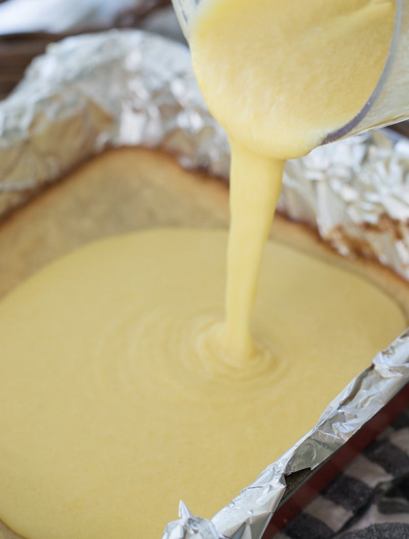 Low carb lemon bar filling being poured into a baking pan. 