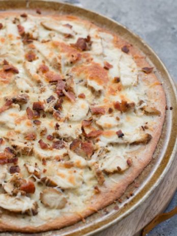 This easy Keto Chicken Bacon Ranch Pizza has a perfectly crispy low carb crust and is loaded with grilled chicken and bacon! Only 3 net carbs per slice!