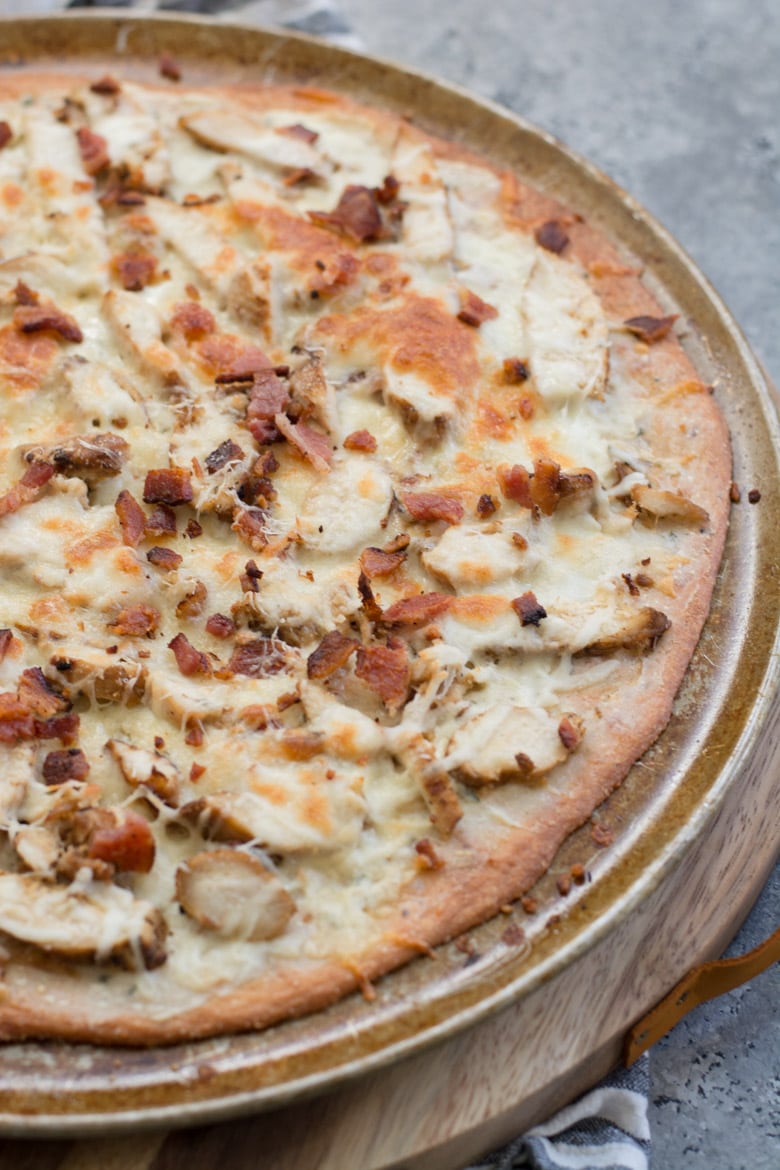 This easy Keto Chicken Bacon Ranch Pizza has a perfectly crispy low carb crust and is loaded with grilled chicken and bacon! Only 3 net carbs per slice!