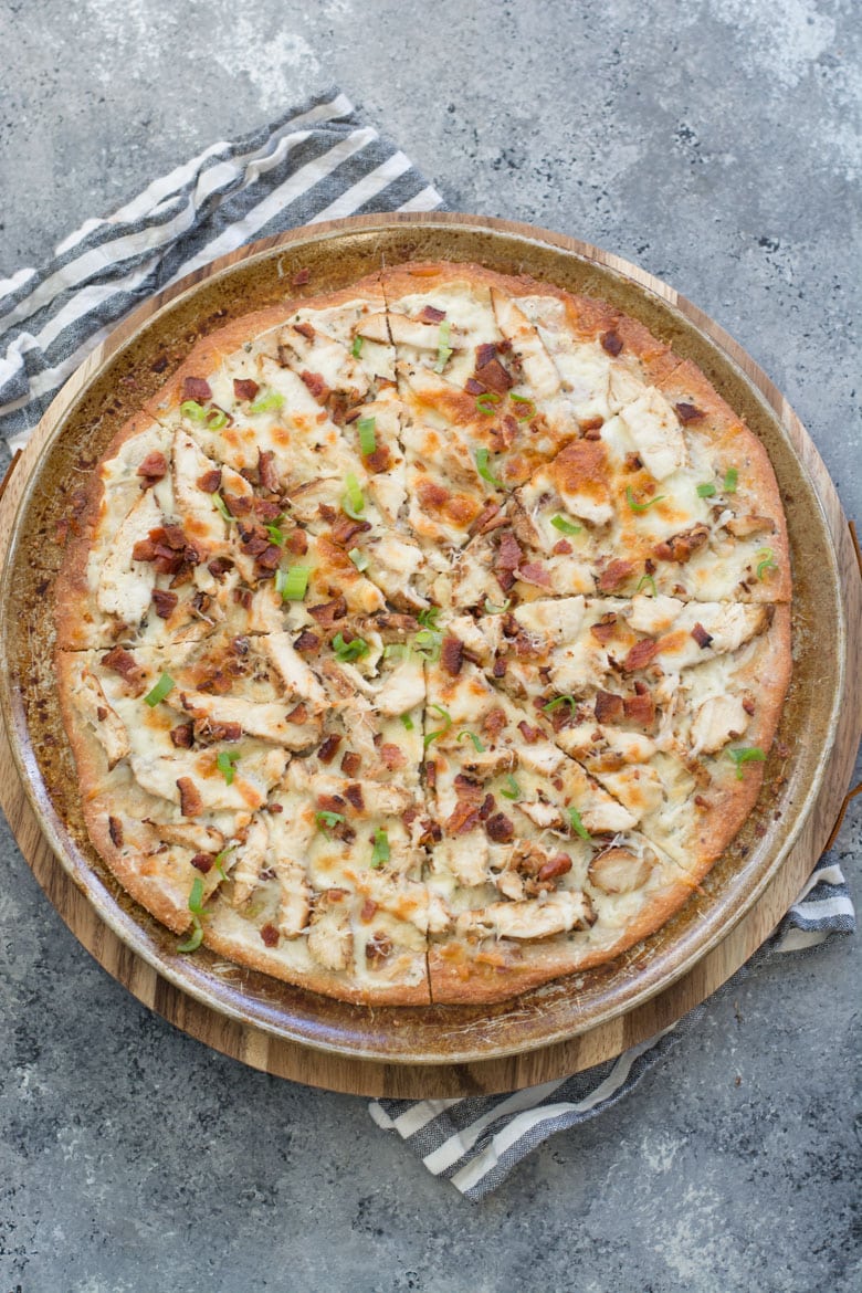 overhead view of a sliced chicken bacon ranch pizza