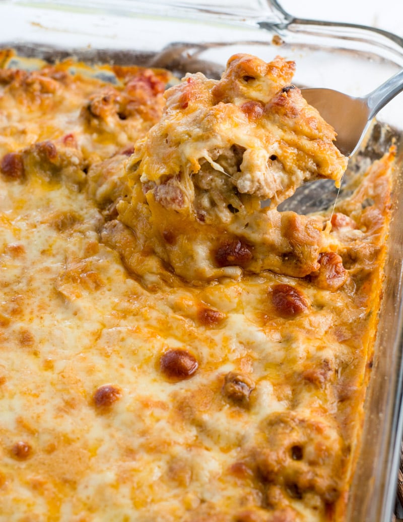 a portion of keto taco casserole being scooped from a baking dish