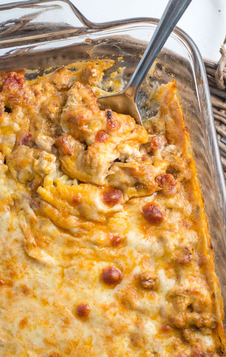 low carb taco casserole in a baking dish, seen from above. a spoon pokes out from the dish. 