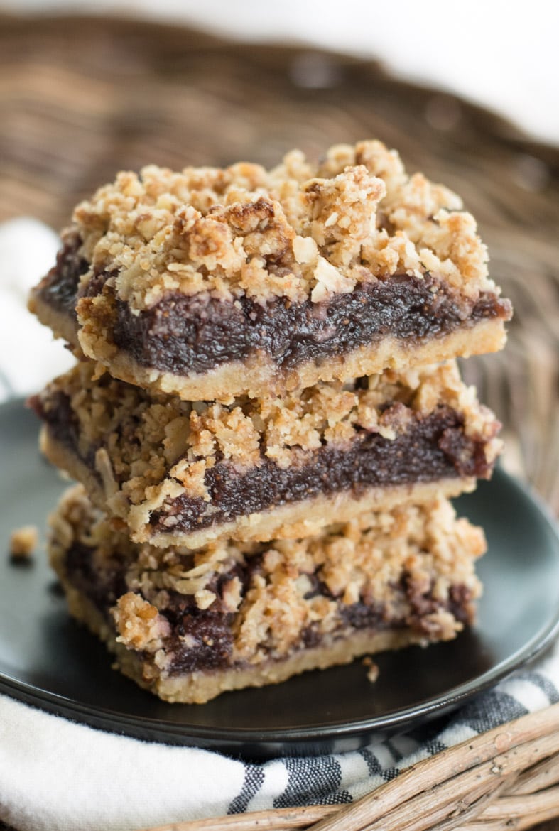 A stack of three homemade fig bars on a gray plate. 