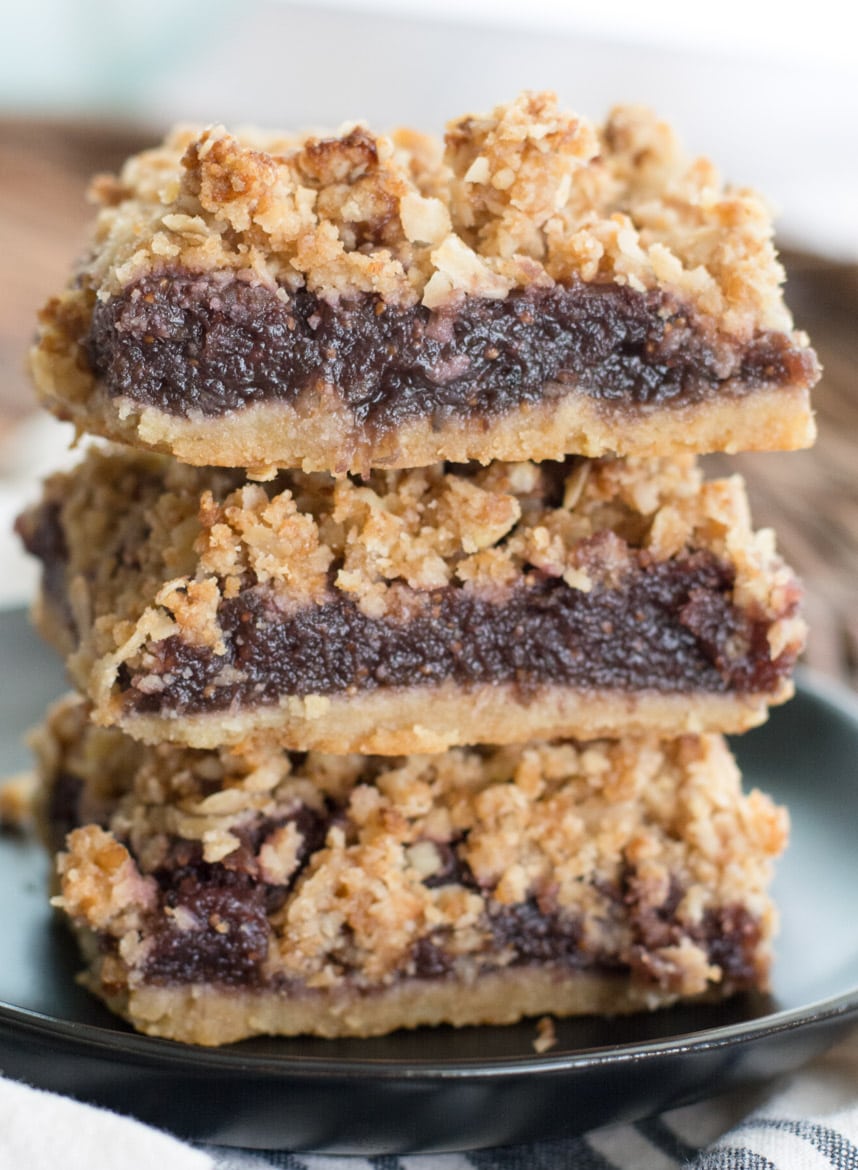 A stack of three homemade fig bars on a gray plate. 
