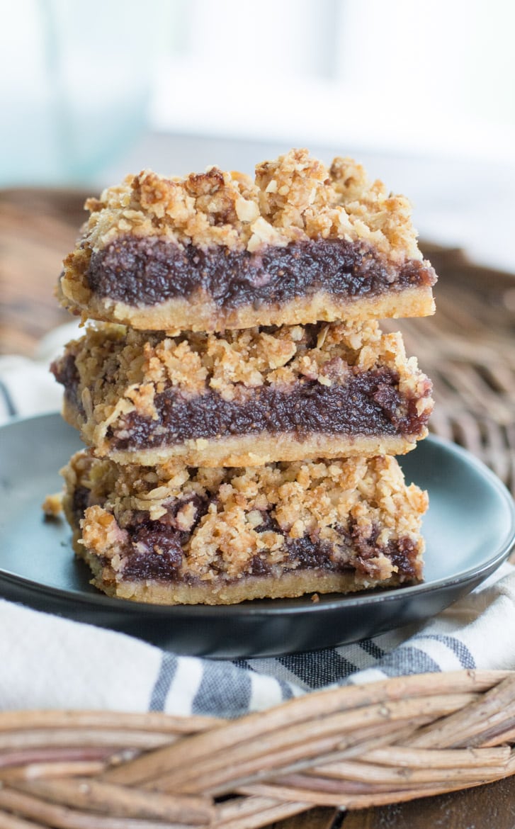 A stack of three homemade fig bars on a gray plate. 