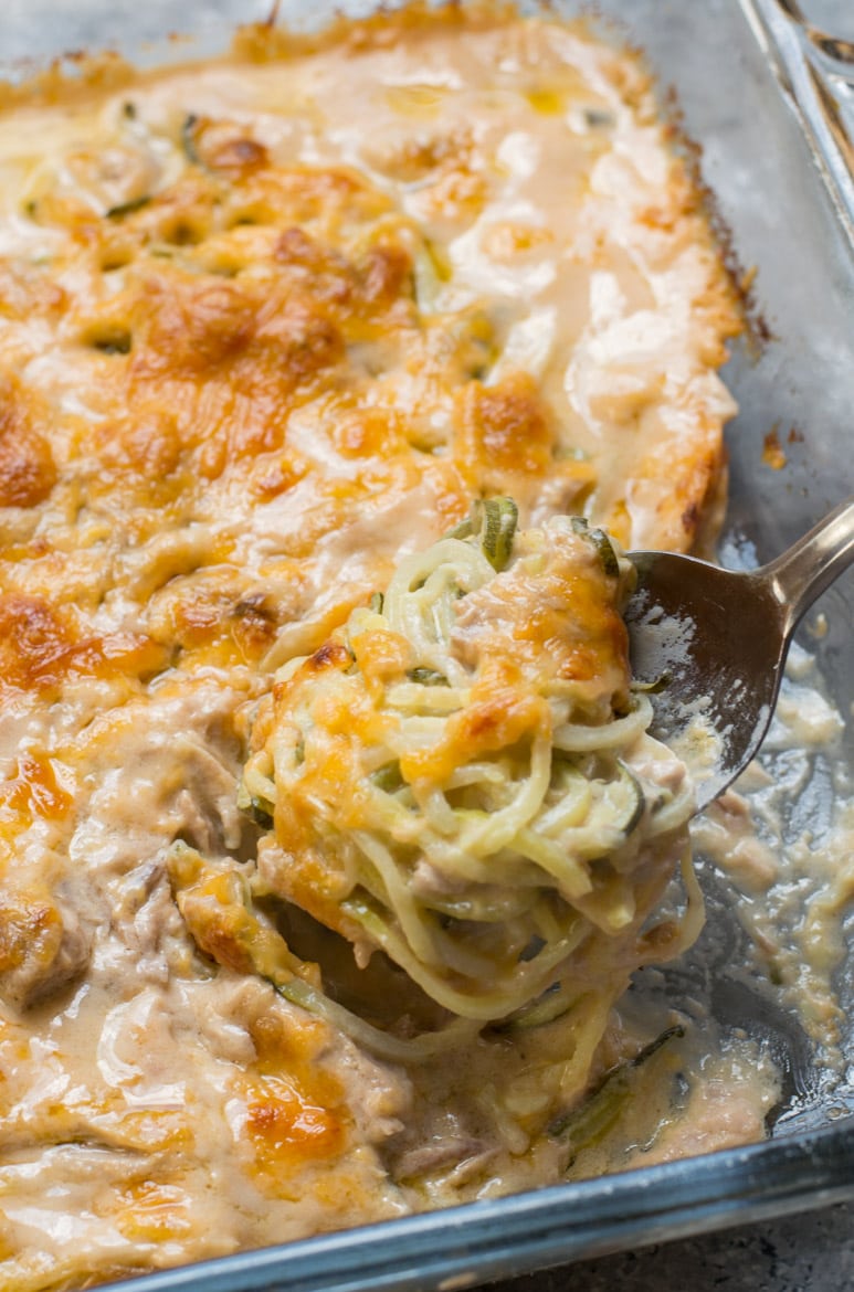 cheesy keto tuna casserole being spooned out of a glass baking dish 