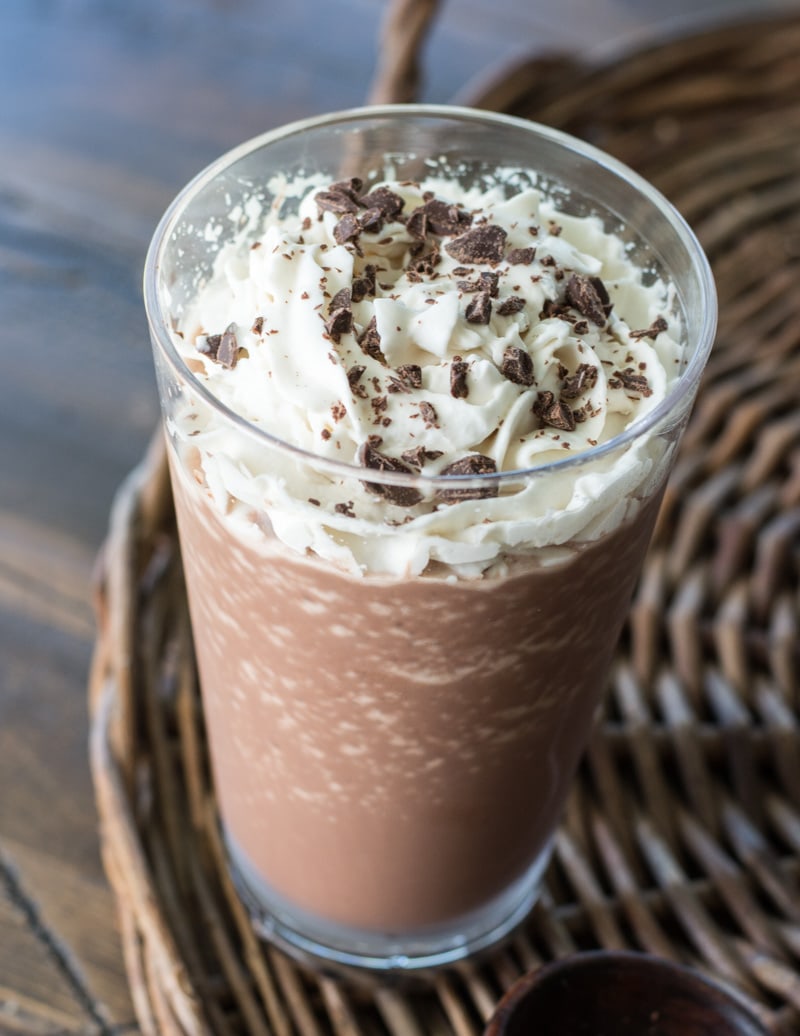 a glass of keto mocha frappuccino topped with whipped cream and chocolate shavings