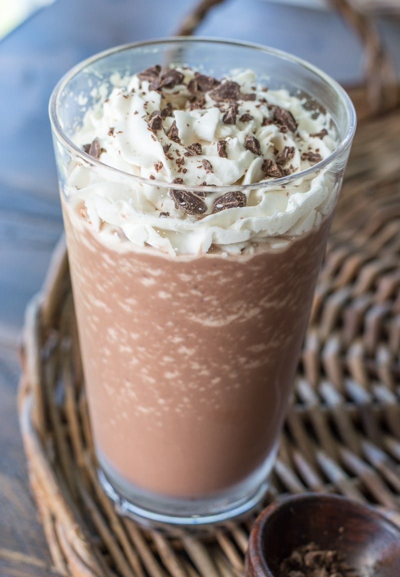 Close up of a glass of keto frappuccino topped with whipped cream and chocolate shavings. 