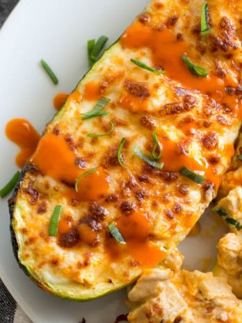 Try these Keto Buffalo Chicken Zucchini Boats packed with tangy buffalo sauce, chicken and cheese! These zucchini boats are cooked in either an air fryer or oven for a delicious low carb meal! #keto