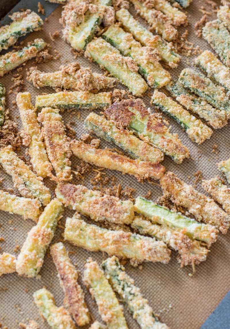 You will love these Keto Zucchini Fries for a low carb side! These fries are breaded with almond flour, parmesan and spices and baked until perfectly crispy!  #keto