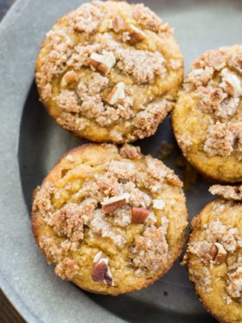 These Keto Pumpkin Muffins are packed with pumpkin spice flavor and topped with a pecan crumble topping! At just 5 net carbs this is a low carb treat you will enjoy all fall long! #keto