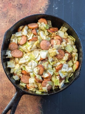 Need an easy low carb, one pan dinner? I've got you covered! This Keto Sausage and Cabbage Skillet is ready in under 20 minutes and has less than 6 carbs per serving! #keto