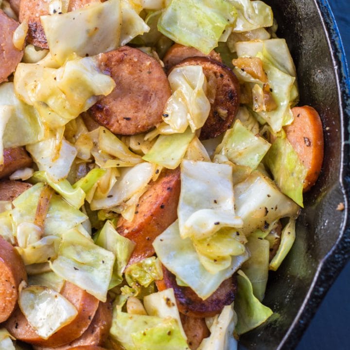 Need an easy low carb, one pan dinner? I've got you covered! This Keto Sausage and Cabbage Skillet is ready in under 20 minutes and has less than 6 carbs per serving! #keto #onepan