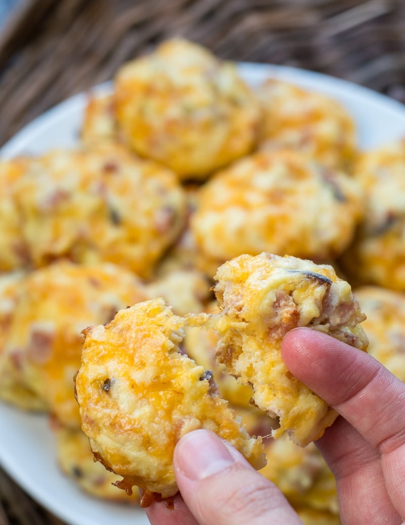 A ham and cheese homemade egg bite being held aloft. 