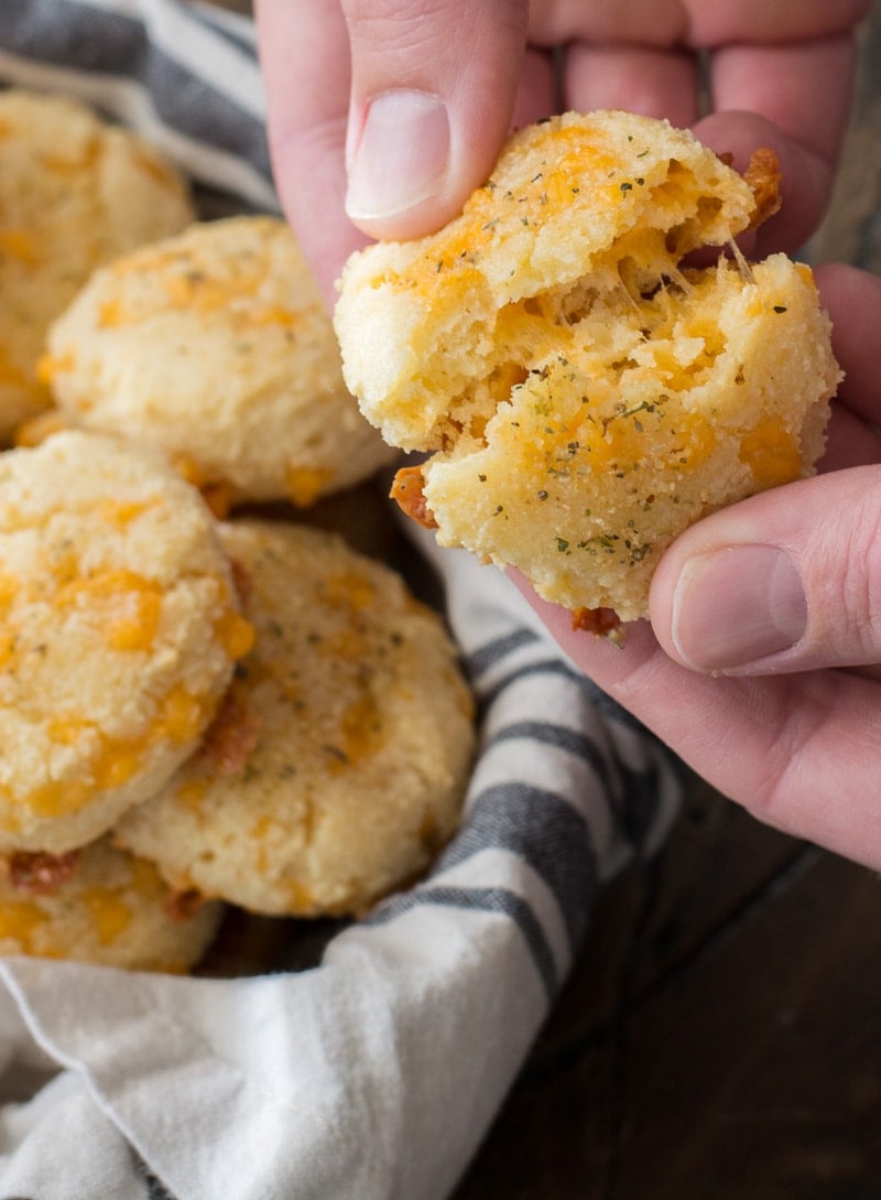 a keto cheddar biscuit being torn in half