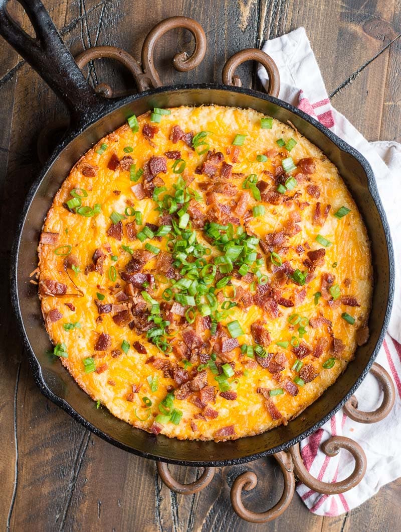 overhead view of keto loaded cauliflower casserole in a cast iron skillet 