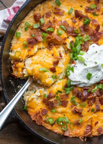If you need a cheesy low carb side this Loaded Bacon Cheddar Cauliflower Casserole is packed with everything you love in a baked potato! At under 8 net carbs this is the perfect holiday keto side dish! #keto