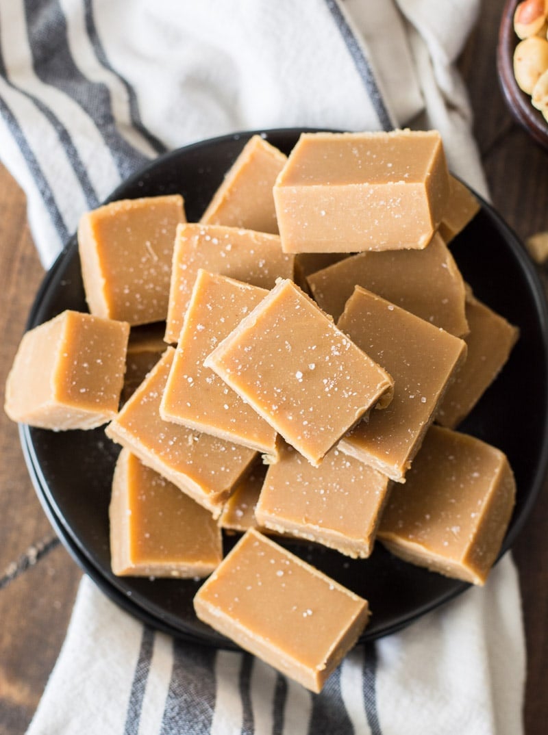overhead view of low carb peanut butter fudge piled on a dark plate 
