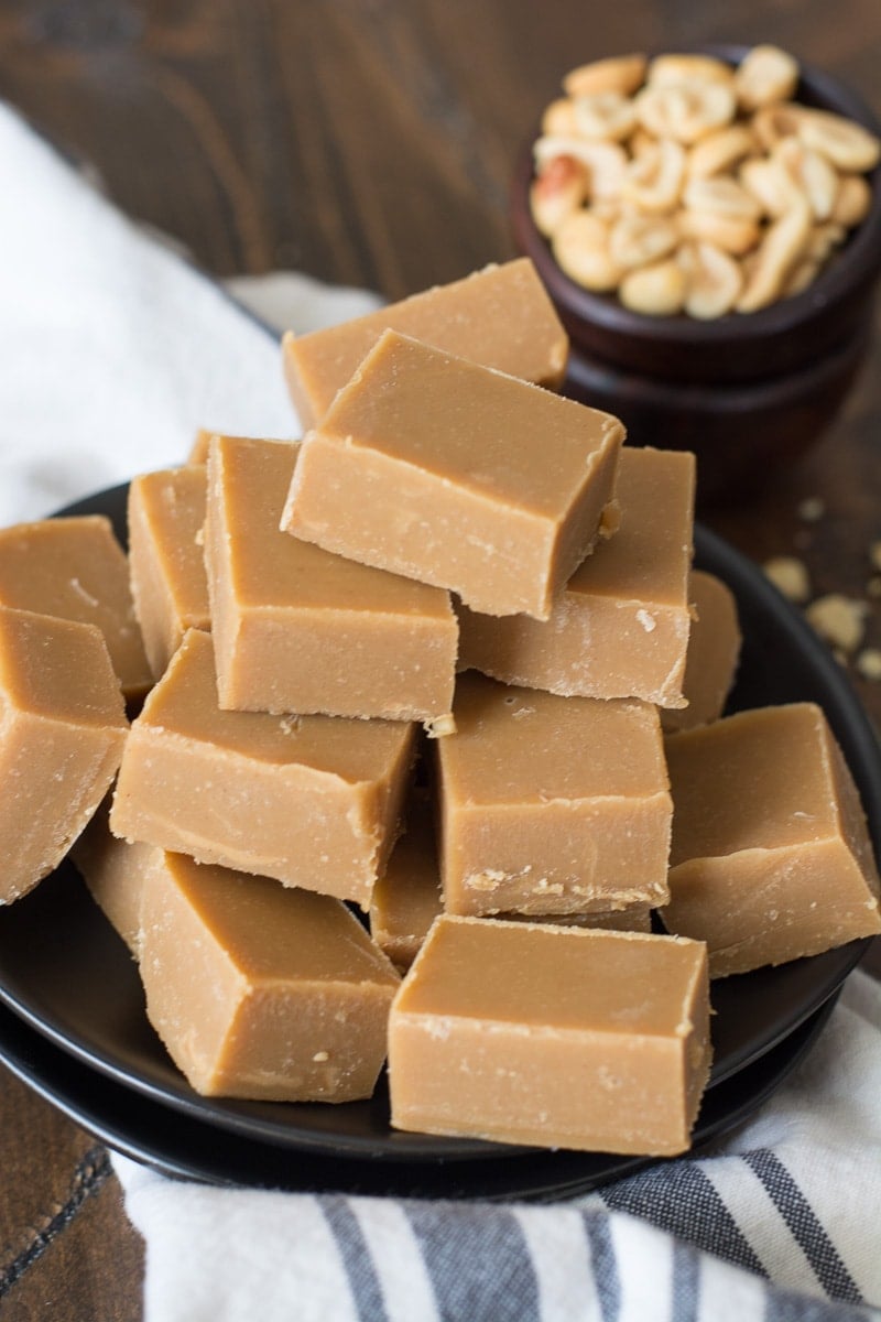 keto friendly peanut butter fudge piled on a dark plate 