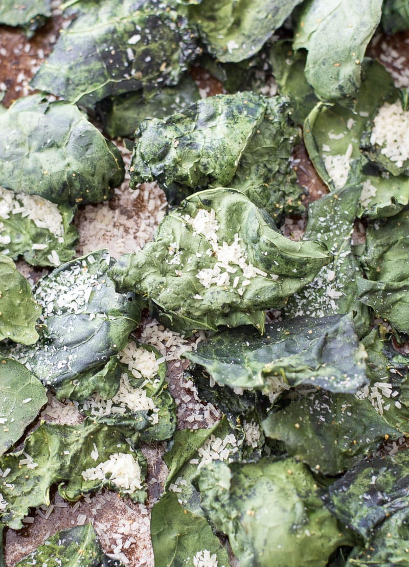 Overhead view of roasted kale chips topped with parmesan 