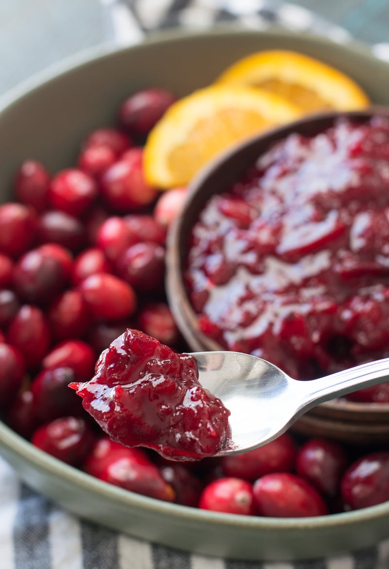 a spoonful of keto cranberry sauce being held aloft 