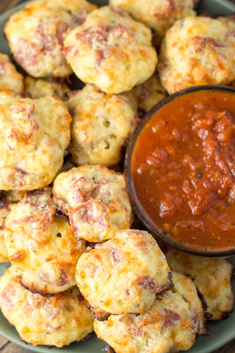 mini pizza bites with a dish of marinara sauce. 