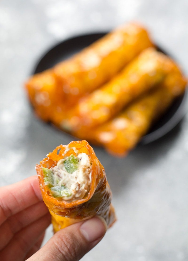 a Jalapeño Popper Keto Taquito being held aloft 