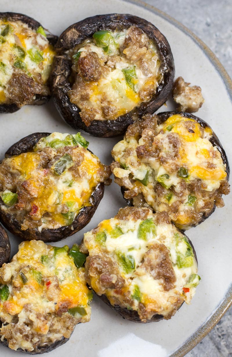 These easy Keto Jalapeno Popper Stuffed Mushrooms are loaded with sausage, peppers and cheese! This is the perfect low carb keto dinner or appetizer at only 5 net carbs per serving!