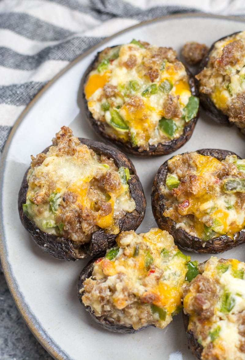 These easy Keto Jalapeno Popper Stuffed Mushrooms are loaded with sausage, peppers and cheese! This is the perfect low carb keto dinner or appetizer at only 5 net carbs per serving!