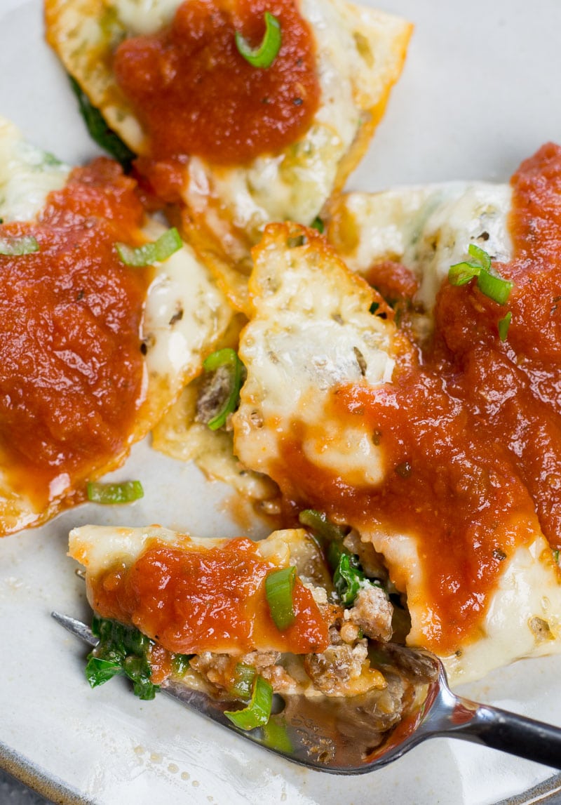 Close up of keto ravioli topped with marinara sauce. 