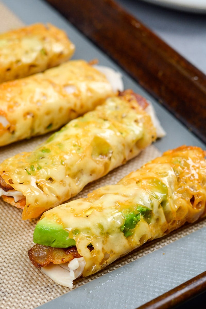 Oven Baked Taquitos with Turkey, Bacon, and Avocado on a silicone mat
